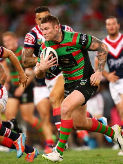 Chris McQueen of Souths runs the ball hard at the Roosters.  (Photo by Mark Nolan/Getty Images)