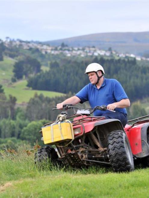 Chris Medlicott demonstrates his modified quad bike on his Kaikorai Valley lifestyle block. Photo...