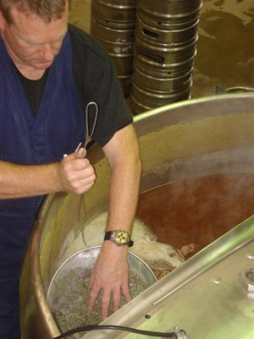 Chris O'Leary, Emerson's production manager, puts thyme into the tank.
