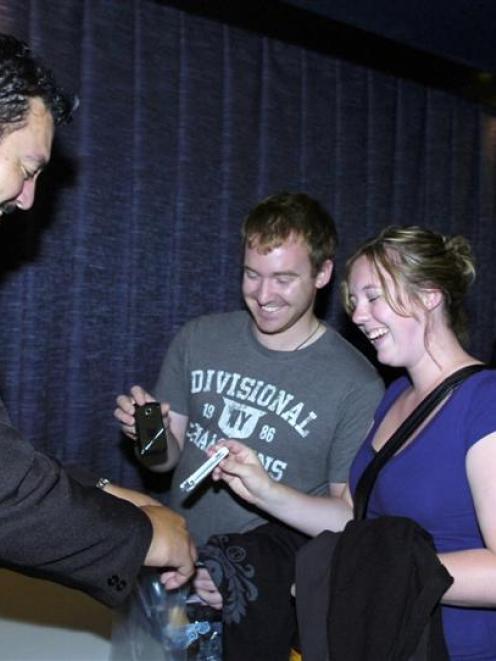 Chris Painter and Lisa Brown surrender their cellphones to Opel Security officer John Kena before...