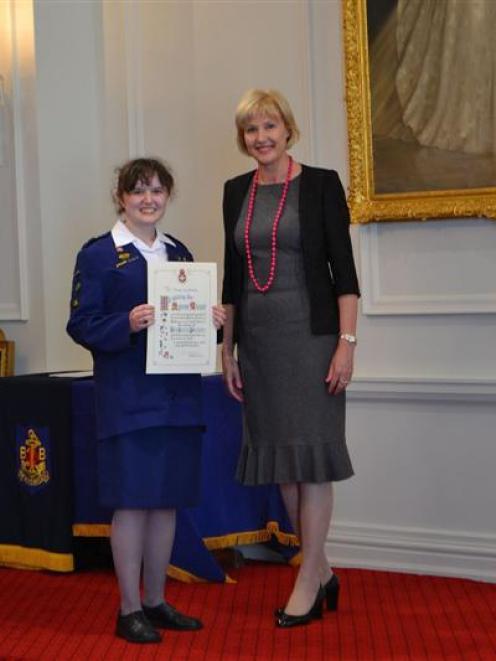 Christy Nicholls is all smiles after being presented with her Queen's Award certificate by Janine...