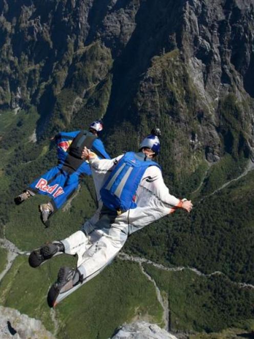 Chuck Berry base-jumps with  fellow dare-devils above   Milford Sound. Photo supplied.