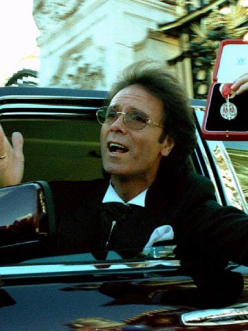 Cliff Richard leaves Buckingham Palace after picking up his knighthood from Queen Elizabeth in...