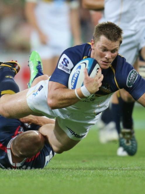 Clyde Rathbone of the Brumbies is tackled by James O'Connor of the Rebels during their match at...
