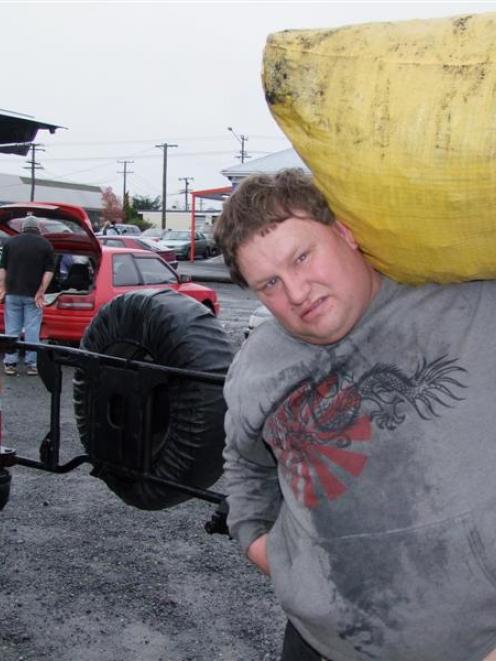 Martin Wilson, of Balclutha, shoulders a free bag of coal on Saturday. photo by Glenn Conway