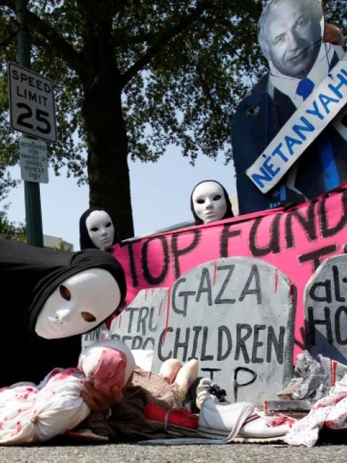 Codepink activists, dressed to symbolise those wounded and killed in Gaza, rally outside the...