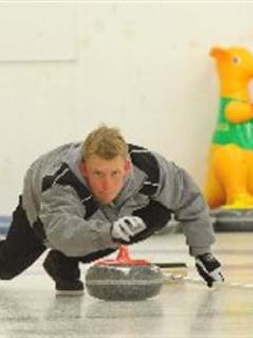 Colby Oracheski plays for the Dave Thomas team at the Maniototo Curling Rink in Naseby yesterday....