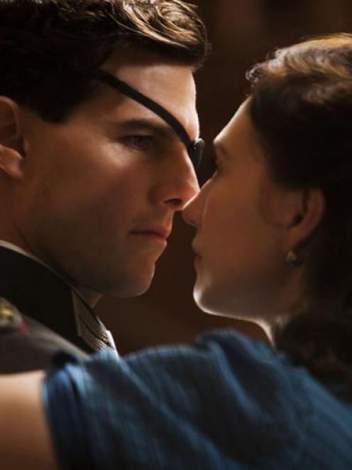 Colonel Claus von Stauffenberg (Tom Cruise) gets close to his wife, Nina (Carice Van Houten), in...