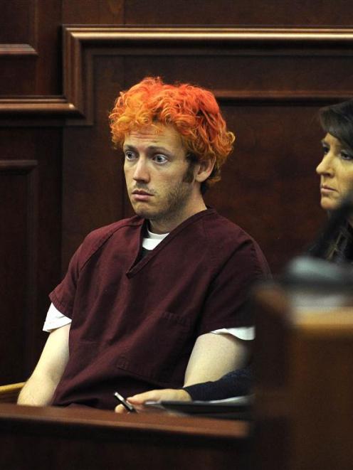 Colorado shooting suspect James Eagan Holmes sits with public defender Tamara Brady during his...