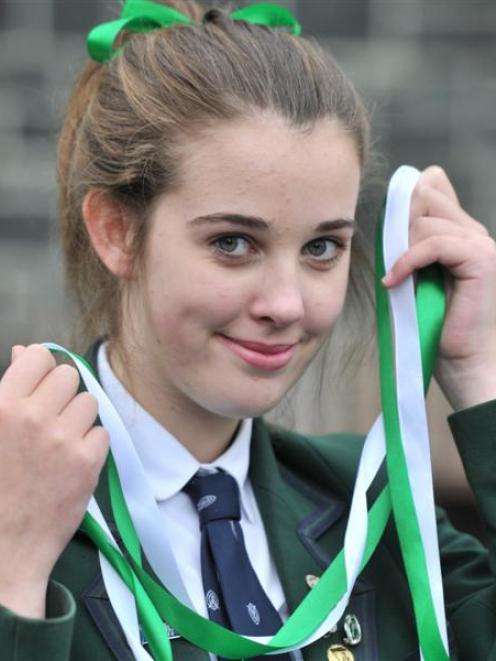 Columba College pupil Caitlin Addison (17) with green and white ribbons which will be worn by...