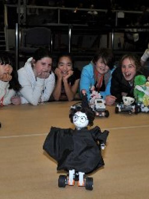 Columba College pupils line up to watch Molly Inman (13) put her "Harry Potter" robot through its...
