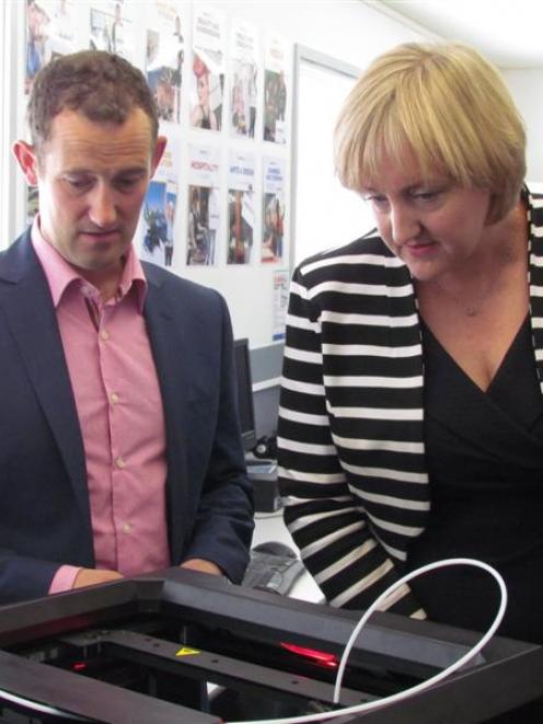 Communications Minister Amy Adams inspects  a 3-D printer with Richard Spackman from Heartland...