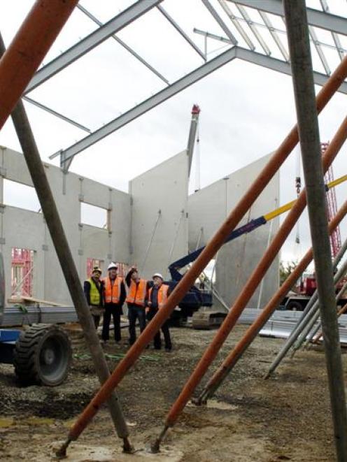 Work proceeds on the East Otago community sports and cultural centre as (from left) site foreman...