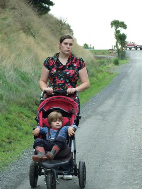 Concerned mother Amanda Duthie pushes her son Michael (2) down Kilgour St, Waihola. Photo by...