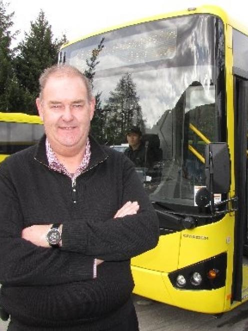 Connectabus owner Ewen McCammon stands beside a new 41-seat Connectabus which entered service...