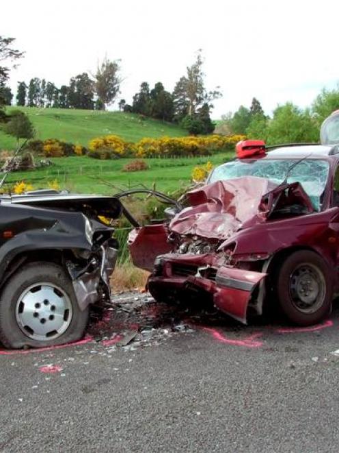 Constable Logan Dickie, of Balclutha, marks out the scene of yesterday's fatal collision near...