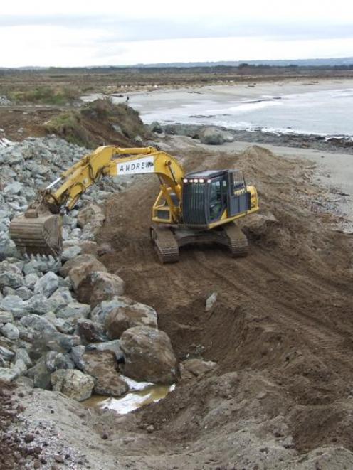 Contractors build an  armoured wall to protect the old dump near Kaka Point from further erosion....