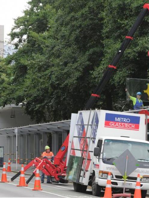 Contractors yesterday removed glass sheets from a veranda outside the University of Otago's...