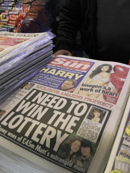 Copies of The Sun newspaper are seen for sale at a newsstand in London.  REUTERS/Olivia Harris