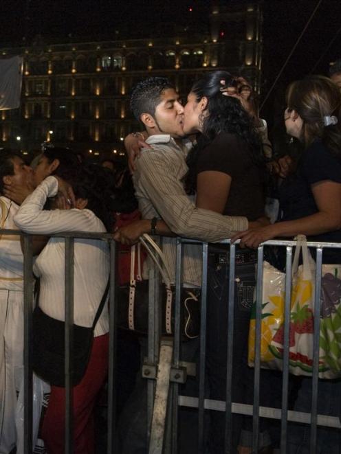 Couples kiss in Mexico City. Thousands gathered in Mexico City's central plaza to pucker up for...