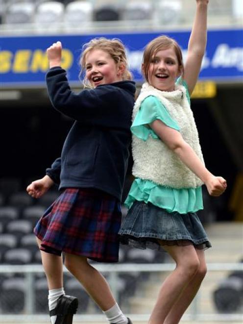 Cousins Lily and Lucy Woodhouse (both 9) dance on the pitch at the sound check. Photos by Peter...