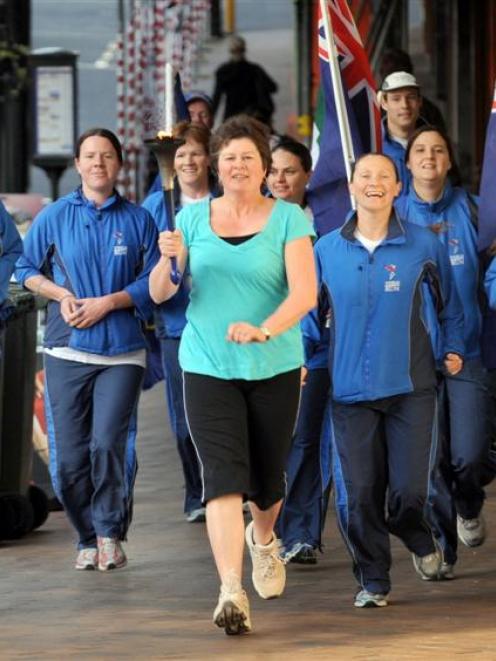 Cr Fliss Butcher leads a group running for world harmony into the Octagon, in 2008. Photo from...