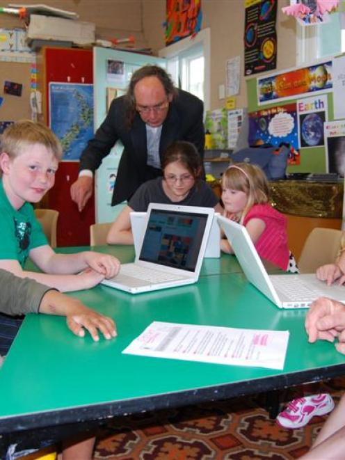 Creating New Zealand flags online at Wakari School on Wednesday are (from left) Harper Rovi (6),...