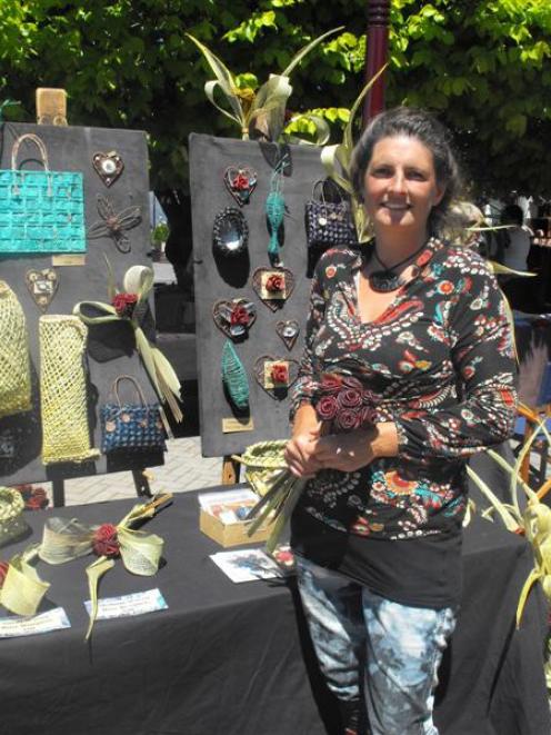 Creative Queenstown Art and Crafts Market manager Jasmine Clark holds a bouquet at her flax and...