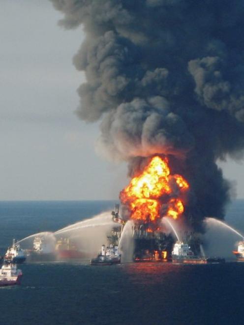 Crews battle the blazing remnants of the offshore oil rig Deepwater Horizon, off Louisiana, in...