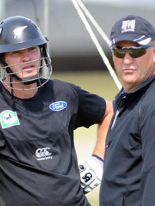 Tim McIntosh, left, receives advice from coach Mark Greatbatch