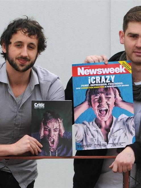 Critic designer  Sam Clark and editor Joe Stockman hold up the cover Critic staff  designed for...