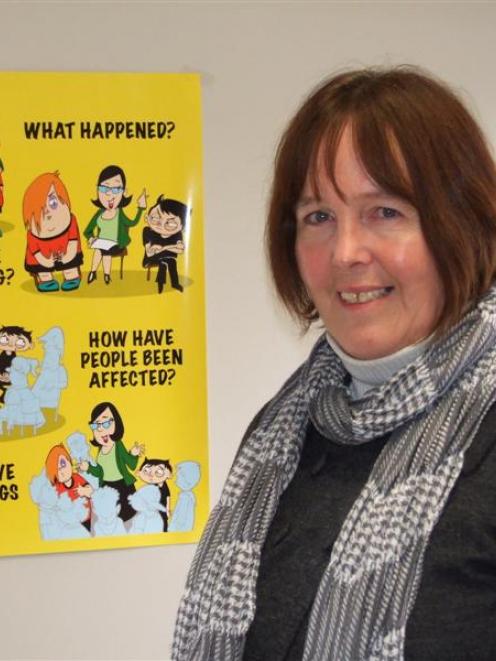 Cromwell Primary School principal Wendy Brooks with posters outlining some of the key points...
