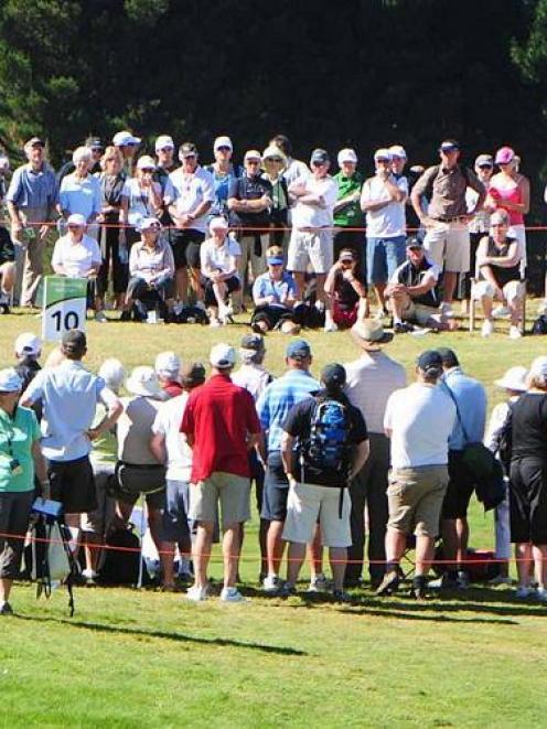 Crowds gather to watch the leaders at the New Zealand Open at The Hills course in Arrowtown today...