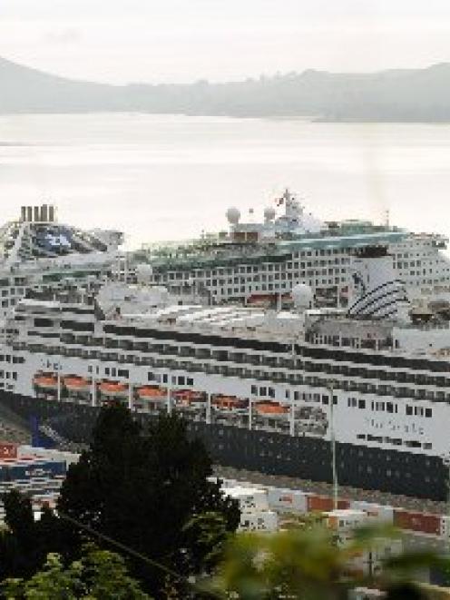 Cruise ship <i>Sea Princess</i> (left) slips into Port Chalmers yesterday morning shortly after...