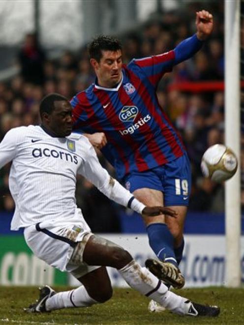 Crystal Palace's Alan Lee, centre, tackles Aston Villa's Emile Heskey during their fifth round FA...