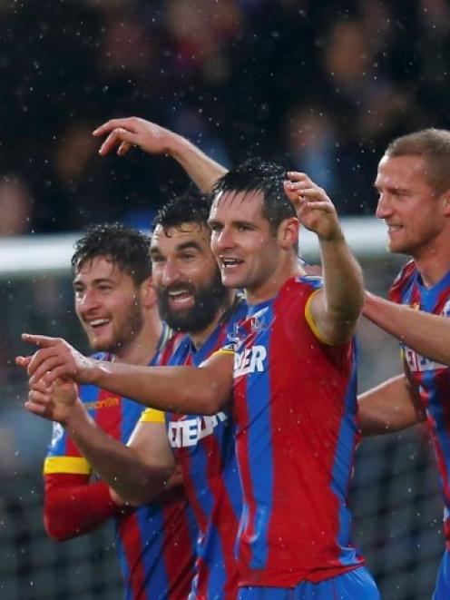 Crystal Palace's Mile Jedinak (2nd L) celebrates with team-mates after scoring against Liverpool....