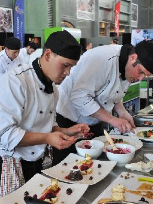Cumberland College chefs Dylan Henry (left) and Brian King put the finishing touches to their two...
