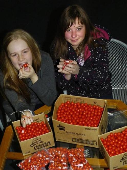 Cure Kids' ambassadors Moneka Prasad-St Clair and Izzy Kloogh try hard to resist the sweet...