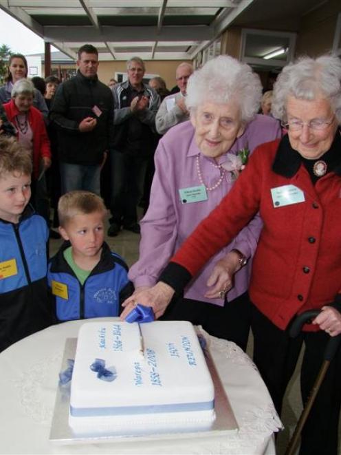 Cutting the cake at Saturday's Warepa-Kaihiku School 150th reunion are (from left) Ryan Dodds (7)...