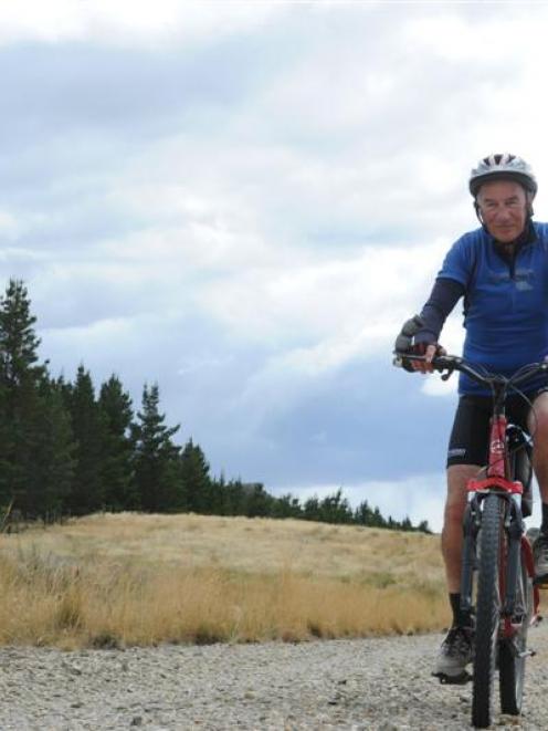 Cyclist  Iain Hickey (81) enjoys a ride on the trail last summer. Photo by Craig Baxter.
