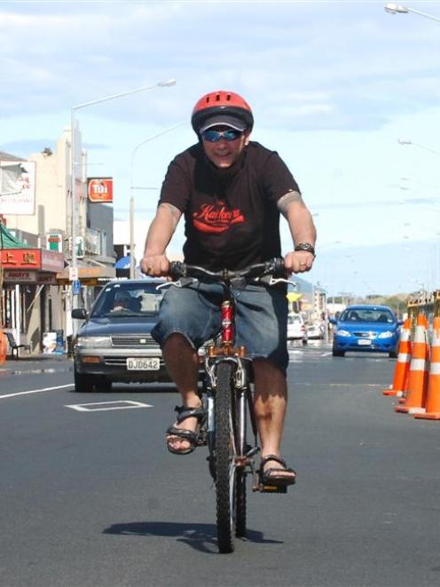 Cyclist Paul Hansen rides along a quiet King Edward St in South Dunedin, yesterday afternoon....