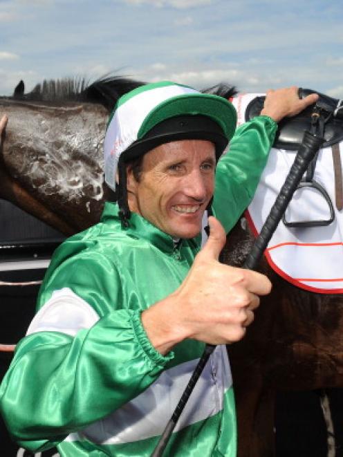 Damien Oliver celebrates winning the AAMI Victoria Derby riding Fiveandahalfstar during Victorian...