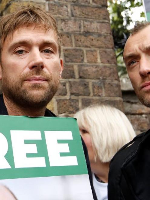 Damon Albarn (L) and Jude Law take part in the protest outside the Russian Embassy in London....