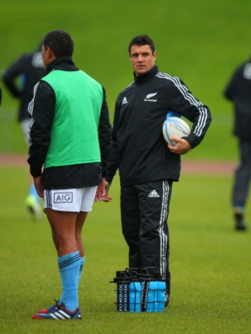 Dan Carter helps deliver water during an All Black training session at Trusts Stadium in Auckland...