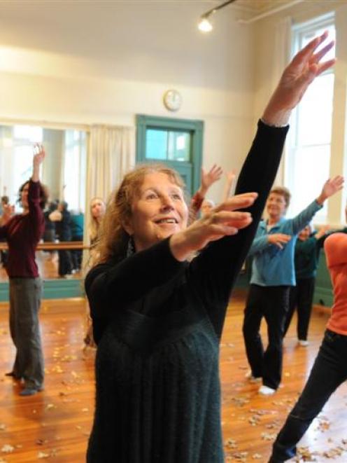 Barbara Snook leads members of a cancer support group through a dance therapy routine. Photo by...