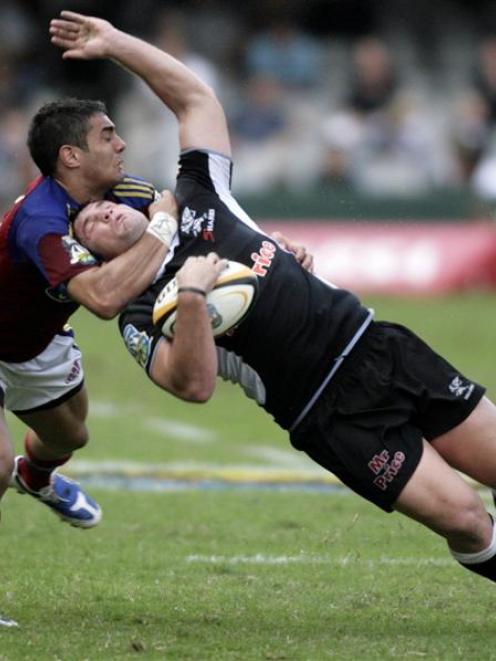 Daniel Bowden, of the Highlanders, tackles Riaan Swanepoel, of the Sharks, during their teams'...