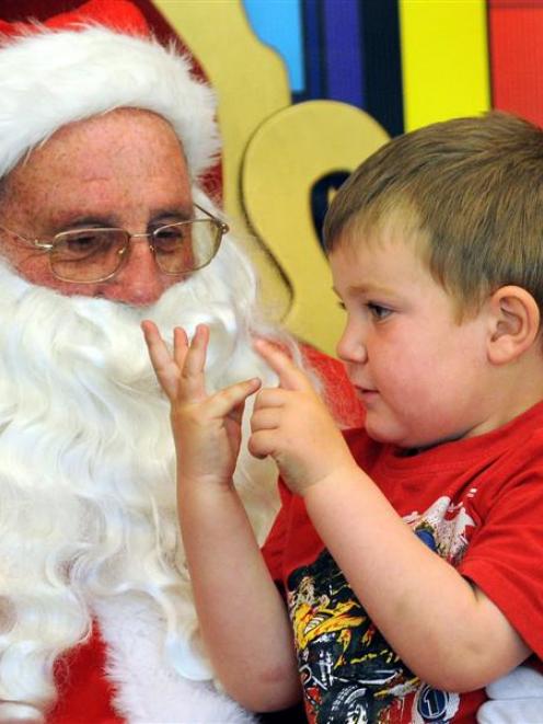 Daniel Dickson (3) tells Santa what he wants for Christmas, in the Meridian mall, Dunedin,...