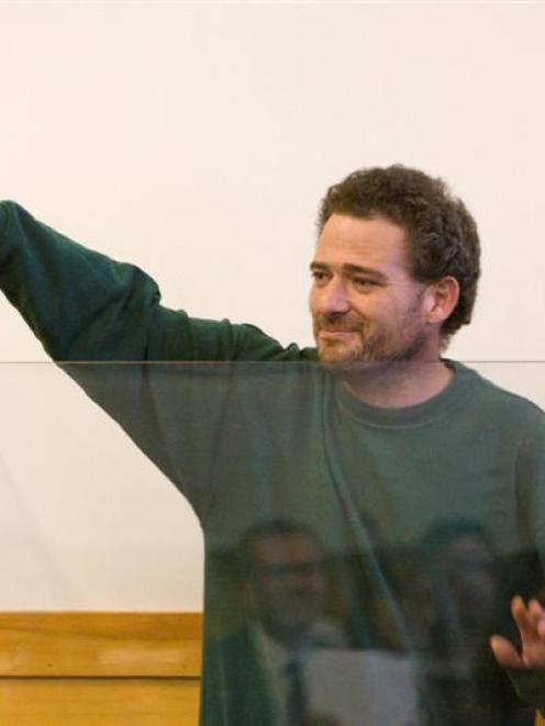 Daniel Vale waves to the public gallery whilst appearing at Waitakere District Court charged with...