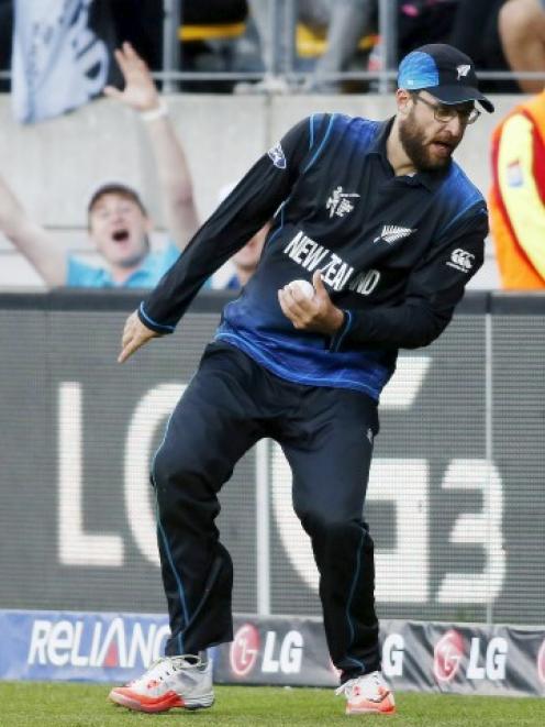 Daniel Vettori looks where his feet are on the boundary after taking the catch to dismiss West...