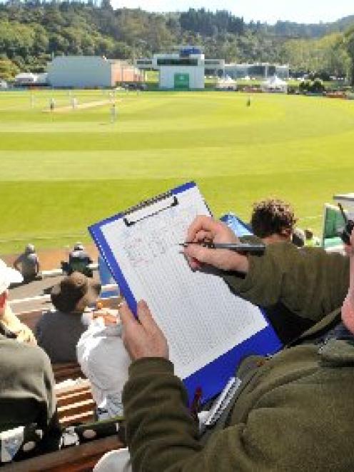 Danny Byrne, of London, briefly takes his eye off the ball at the University Oval yesterday....